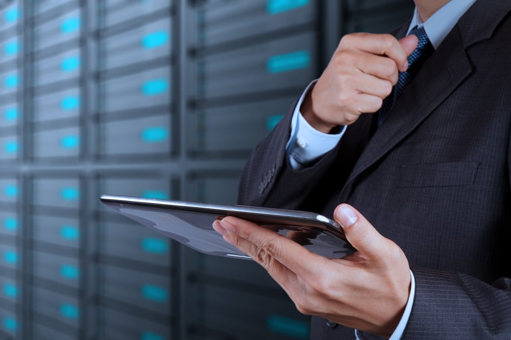 man standing in data center aisle